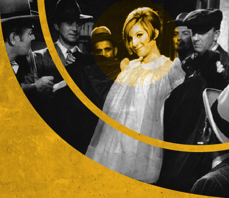 a woman smiling surrounded by men