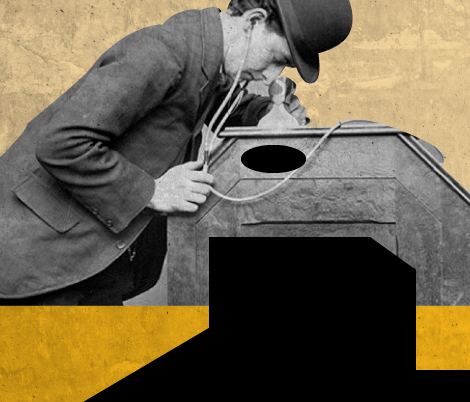 man looking down on an old recording device