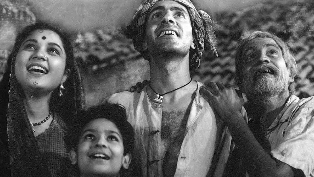 woman, boy, and two men looking up and smiling